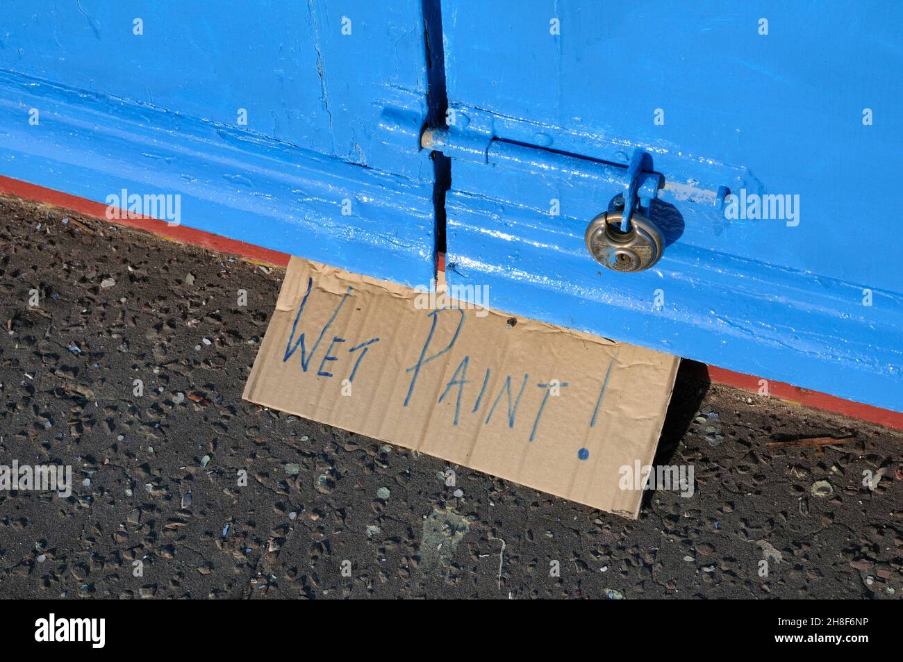 Wet Paint sign written on cardboard Stock Photo