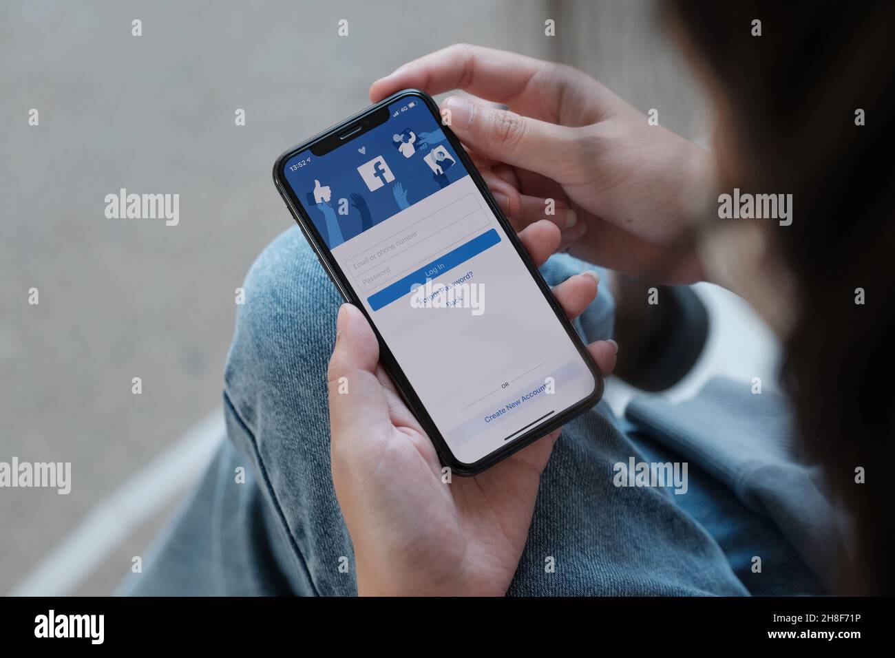 CHIANG MAI, THAILAND - NOV 28, 2021: Facebook social media app logo on log-in, sign-up registration page on mobile app screen on iPhone Xs in person's Stock Photo