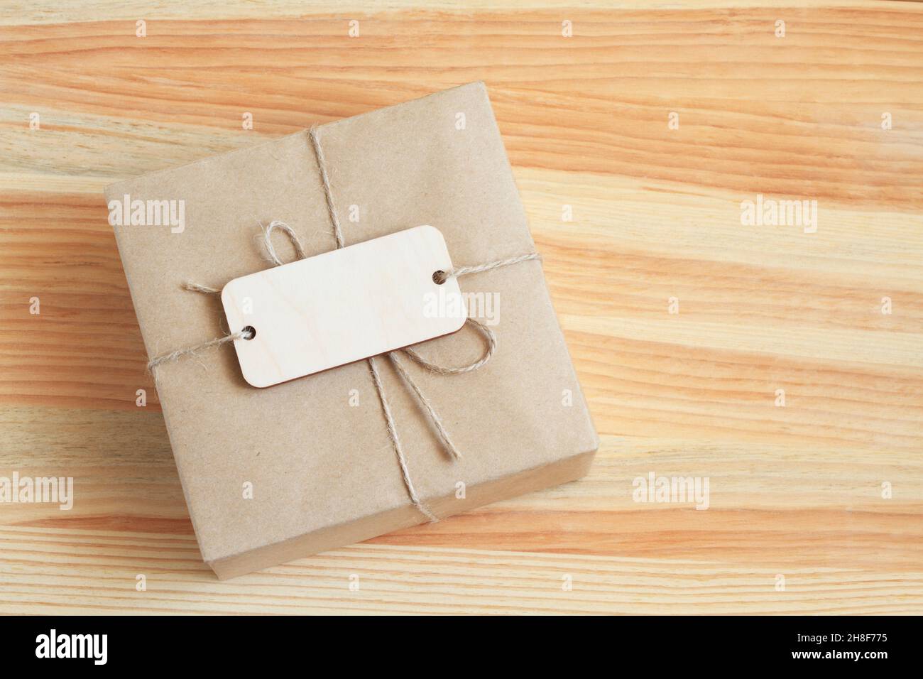 The box, wrapped in rough paper and tied with a rough rope, lies on a ...