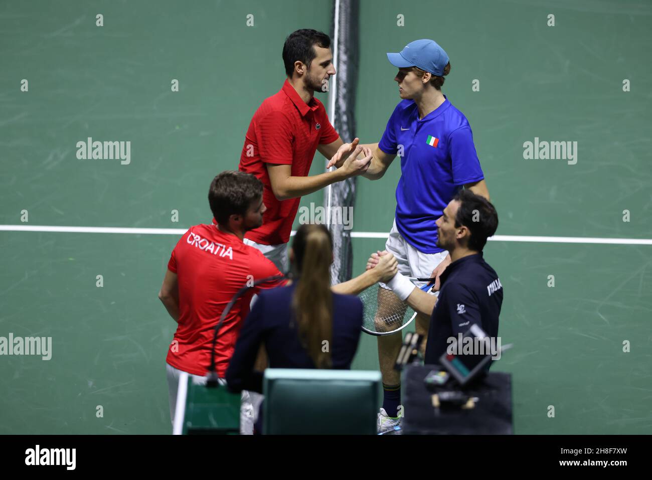 Turin, Italy, 29th November 2021. Mate Pavic and Nikola Mektic of Croatia shake hands with Jannick Sinner and Fabio FOgnini respectively following the quarter final doubles victory for the Croatians and subsequent qualification to the semi finals of of the Davis Cup Finals after the match between Italy and Croatia at Pala Alpitour Arena, Turin. Picture credit should read: Jonathan Moscrop / Sportimage Stock Photo