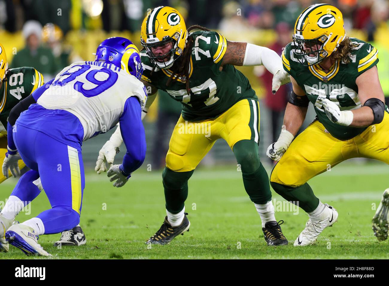 Green Bay, Wisconsin, USA. 28th Nov, 2021. Green Bay Packers offensive tackle Billy Turner (77) and guard Royce Newman (70) take on Los Angeles Rams defensive end Aaron Donald (99) during the NFL football game between the Los Angeles Rams and the Green Bay Packers at Lambeau Field in Green Bay, Wisconsin. Darren Lee/CSM/Alamy Live News Stock Photo
