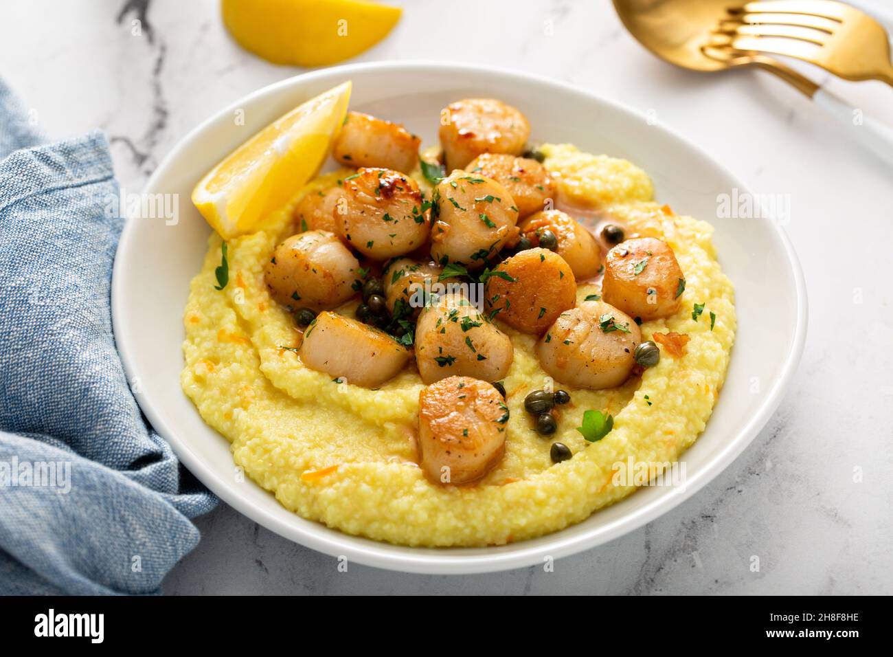 Seared scallops with grits and lemon sauce Stock Photo Alamy