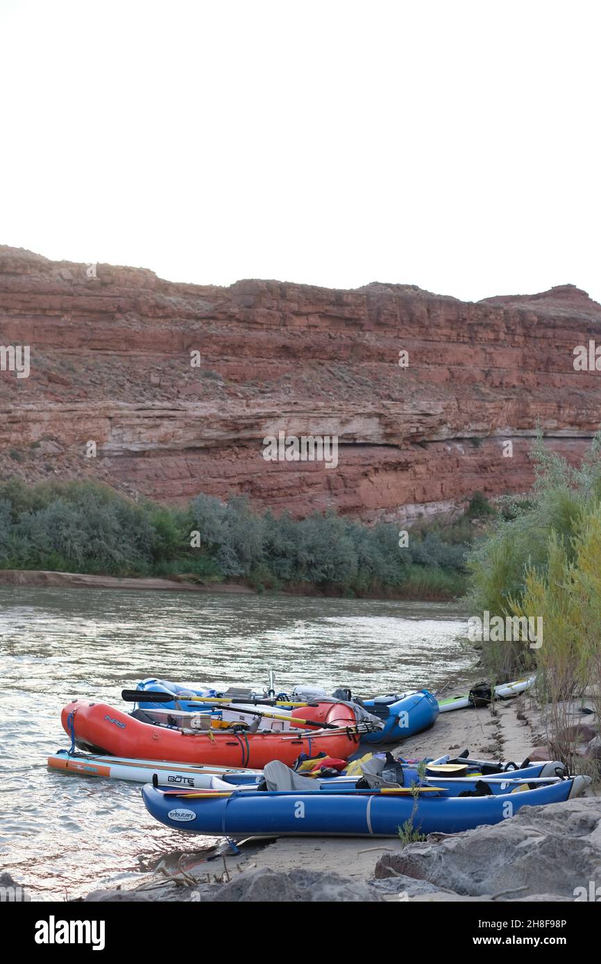 White water rafts and inflatable kayaks parked on the San Juan River at ...