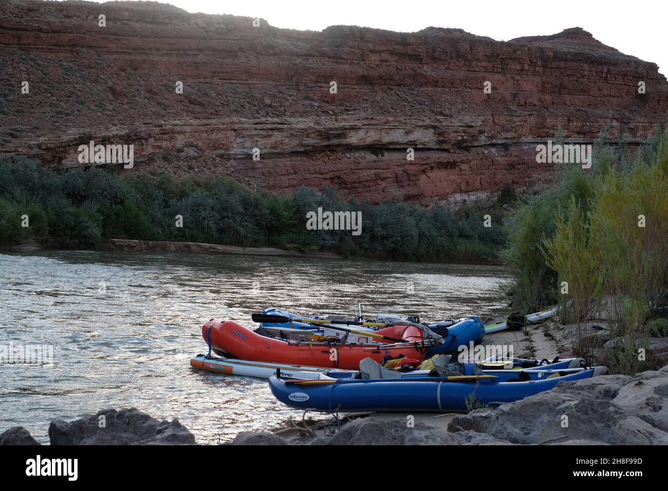 White water rafts and inflatable kayaks parked on the San Juan River at ...