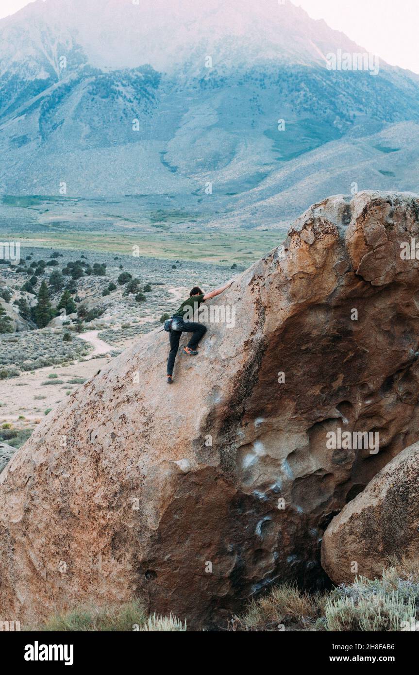 Rock climber bouldering in the Buttermilks, California Stock