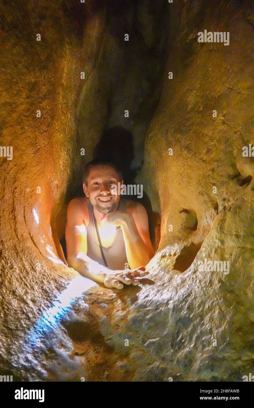 Crawling down the laundry chute, The Royal Arches, Chillagoe, Queensland, Australia Stock Photo