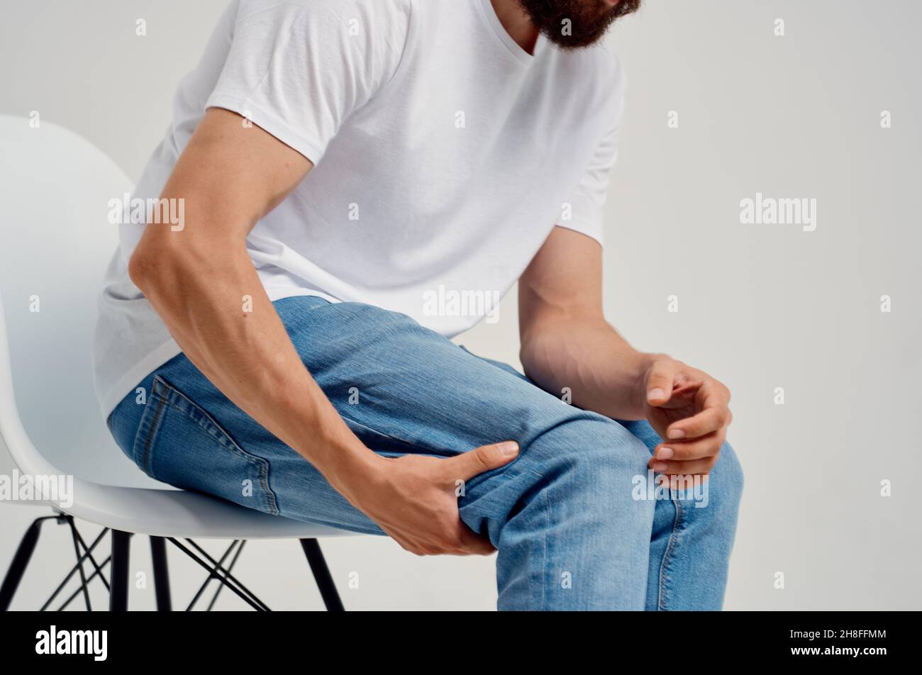 Man sitting on chair leg pain health problems medicine Stock Photo Alamy