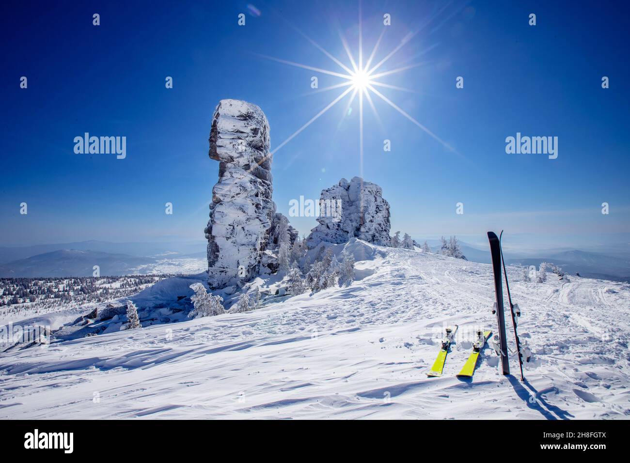 Ski and snowboard background blue sky with sun light frozen rocks, Sheregesh ski resort. Concept extream freeride on fresh snow. Stock Photo