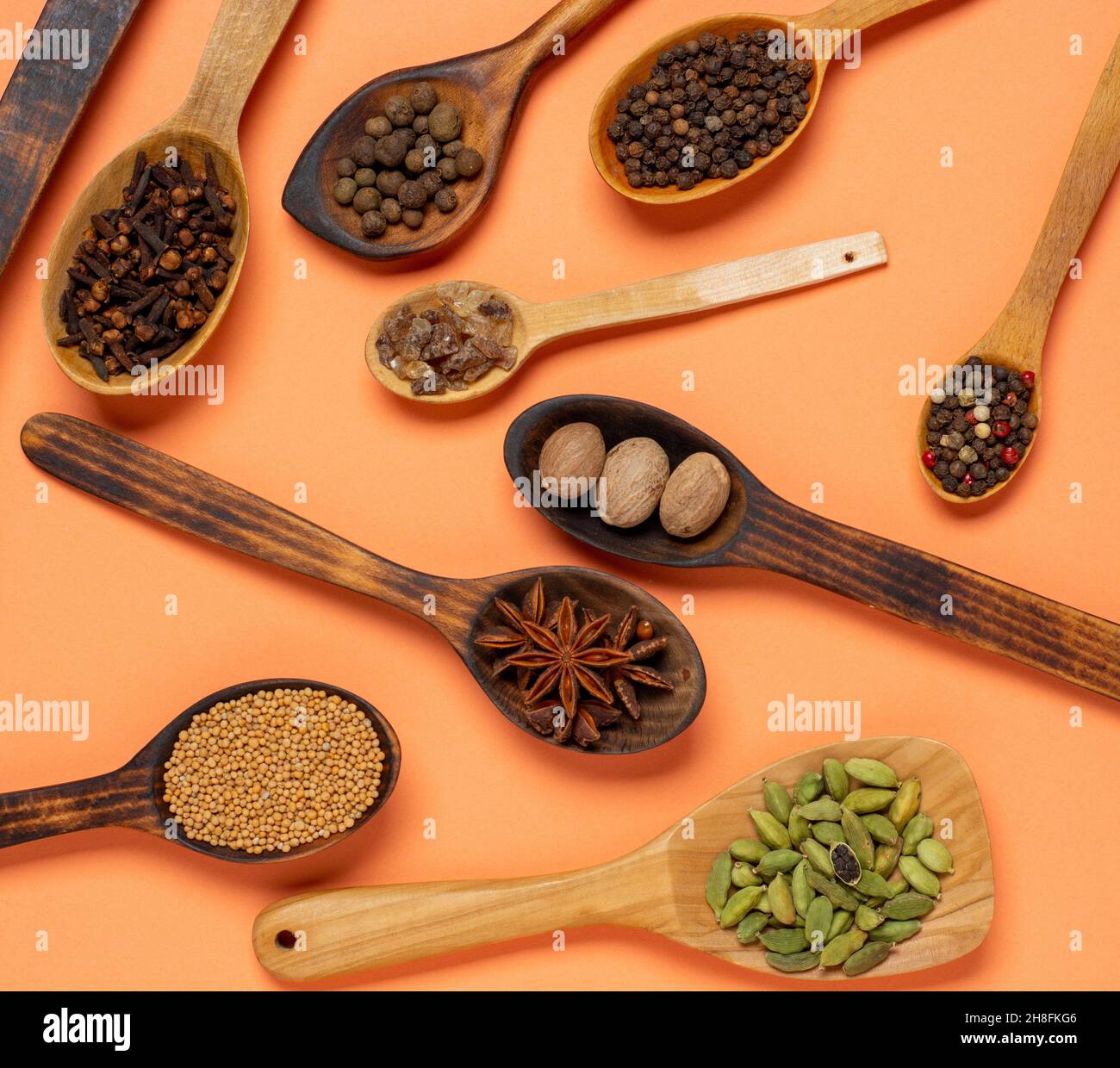 Different spices in spoons colorful background. Flat lay or top view Stock Photo