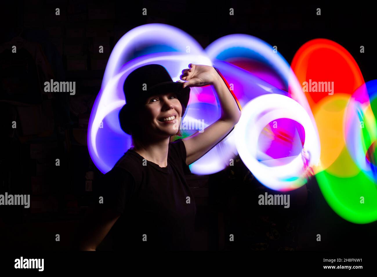 A woman in the dark in a multicolored light. The concept of energy, aura. Stock Photo