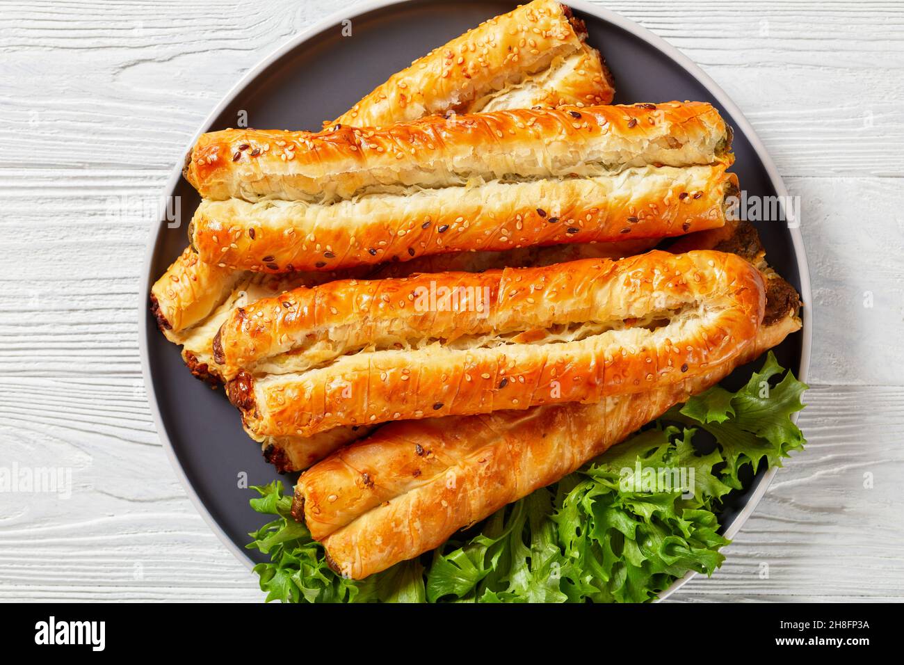 Filo Rollini with spinach, feta cheese, chicken meat filling on a plate ...