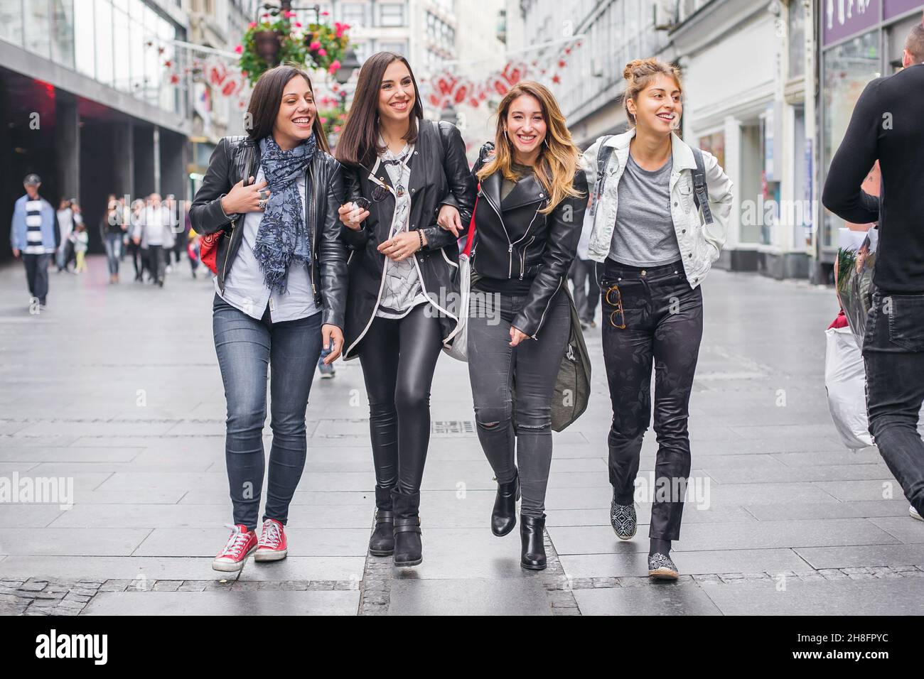Four girls friends, gossip and having fun on the street. Best ...