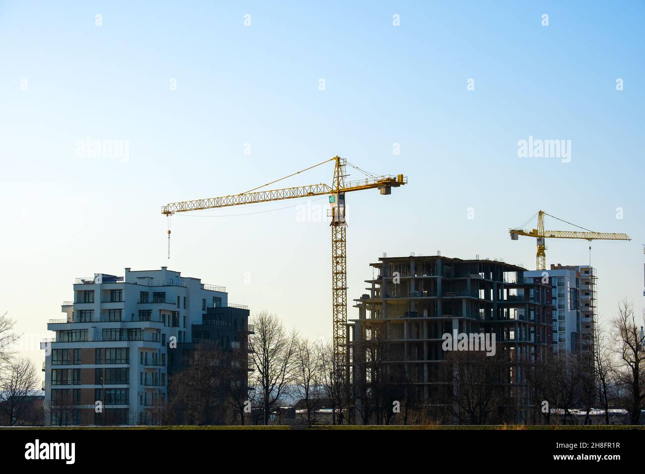 Aerial view of tower cranes and high residential apartment buildings ...