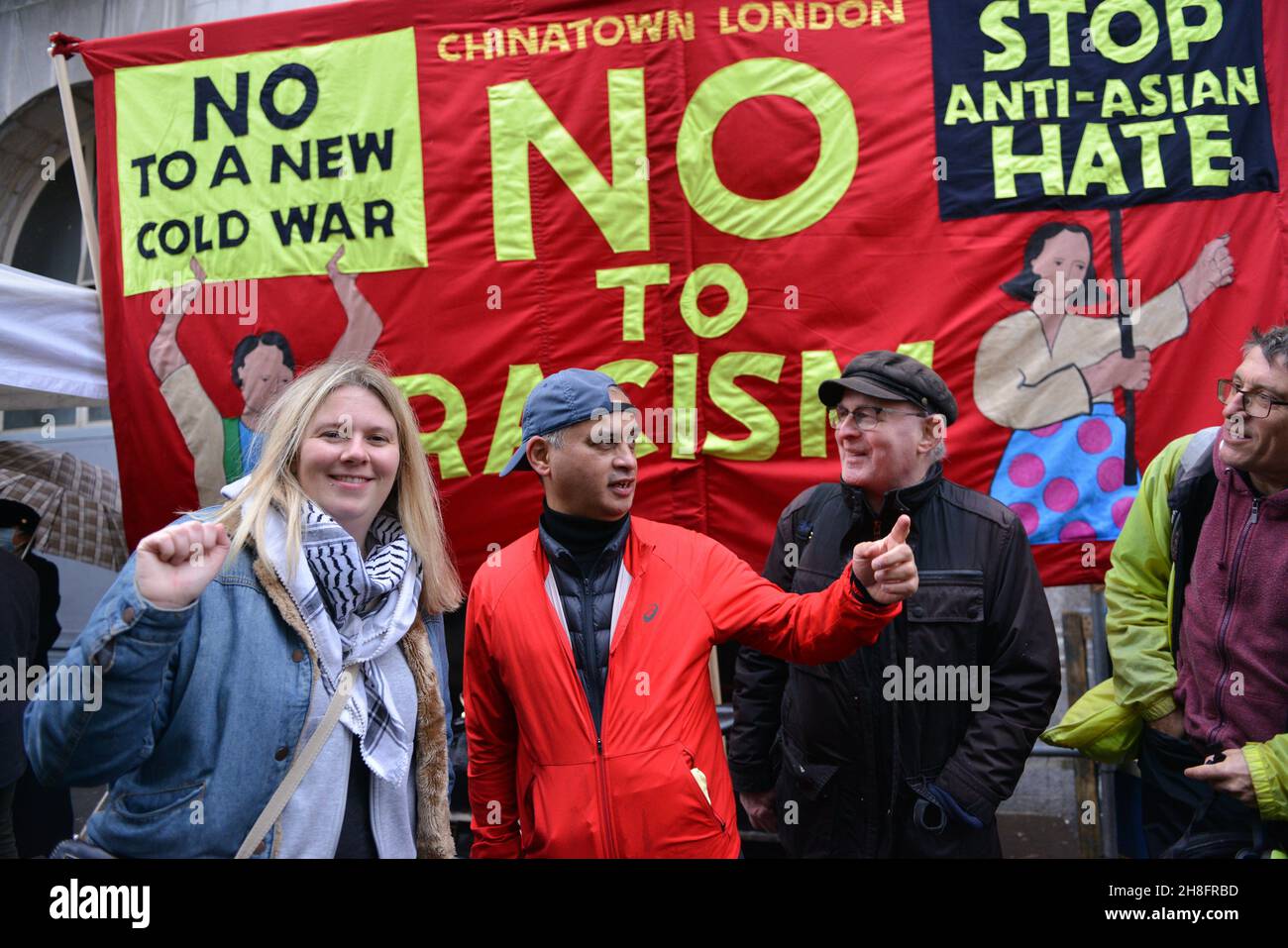 Activists gesture as they take part during the Anti-Asian Hate rally. Dozens of pro democracy, pro Hong Kong independence and anti CCP (Chinese Communist Party) protesters hosted a  counter protest against the Stop Anti-Asian Hate rally 'against the new cold war' organized by the Chinese associations in the UK, in London's Chinatown. Stock Photo
