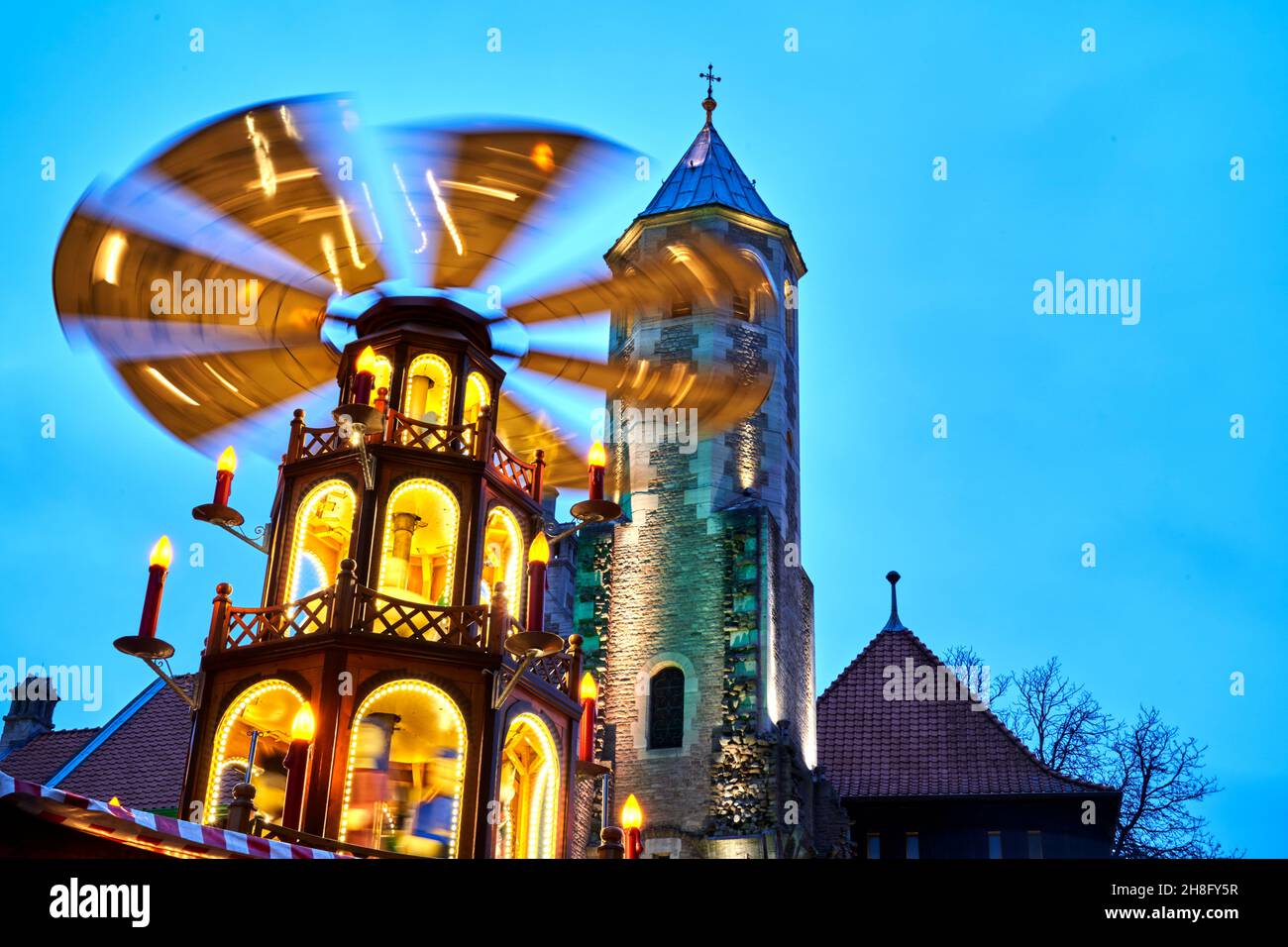 Braunschweig, Germany, November 28, 2021: Rotating illuminated Christmas pyramid in front of the Brunswick Cathedral at the Christmas Market Stock Photo