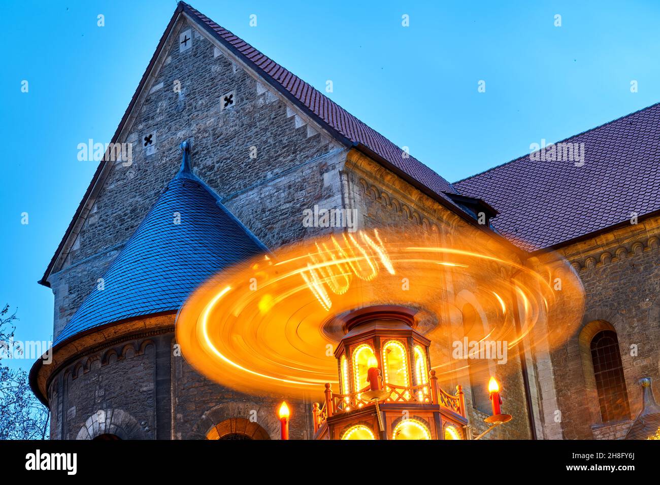 Braunschweig, Germany, November 28, 2021: Rotating illuminated Christmas pyramid in front of the Brunswick Cathedral at the Christmas Market Stock Photo