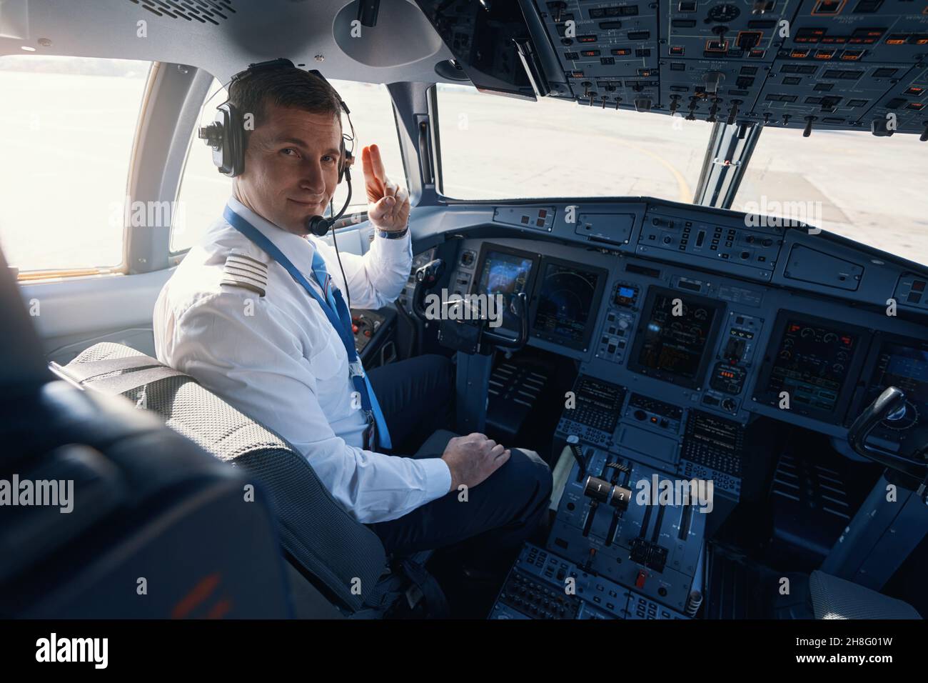 Male Plane Captain Giving Two Finger Salute To Camera Stock Photo Alamy   Male Plane Captain Giving Two Finger Salute To Camera 2H8G01W 