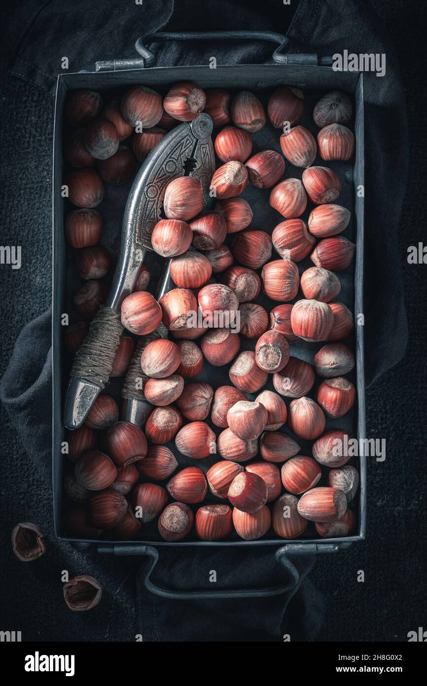 Pile of hazelnuts on dark table. Quick and good snack. Nuts as a source