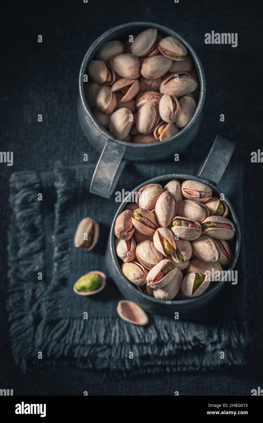 Group of pistachios on dark table. Source of minerals. Nuts as a source