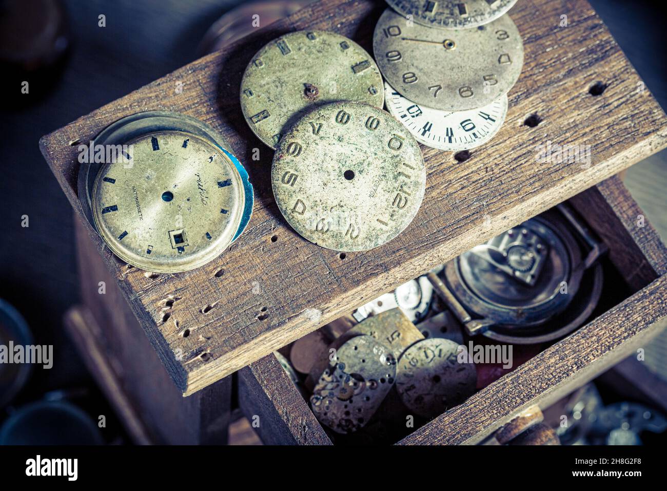 Vintage watchmaker's workplace with repaired clocks.