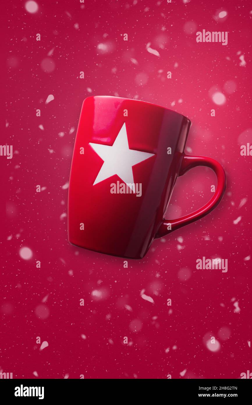 Red Christmas mug with red snowy background. Christmas concept design. Stock Photo