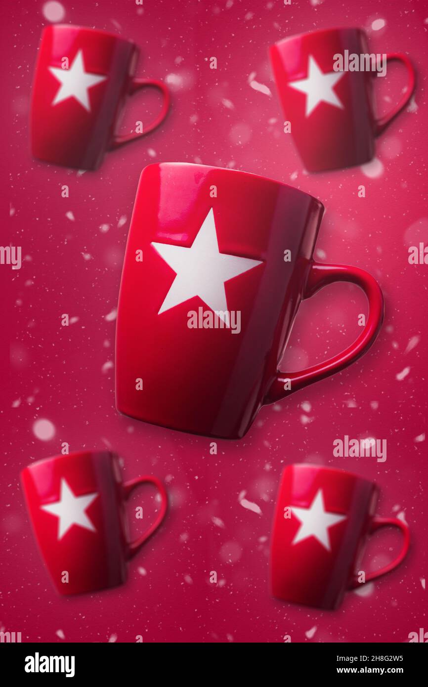 Red Christmas mugs with red snowy background. Christmas concept design. Stock Photo