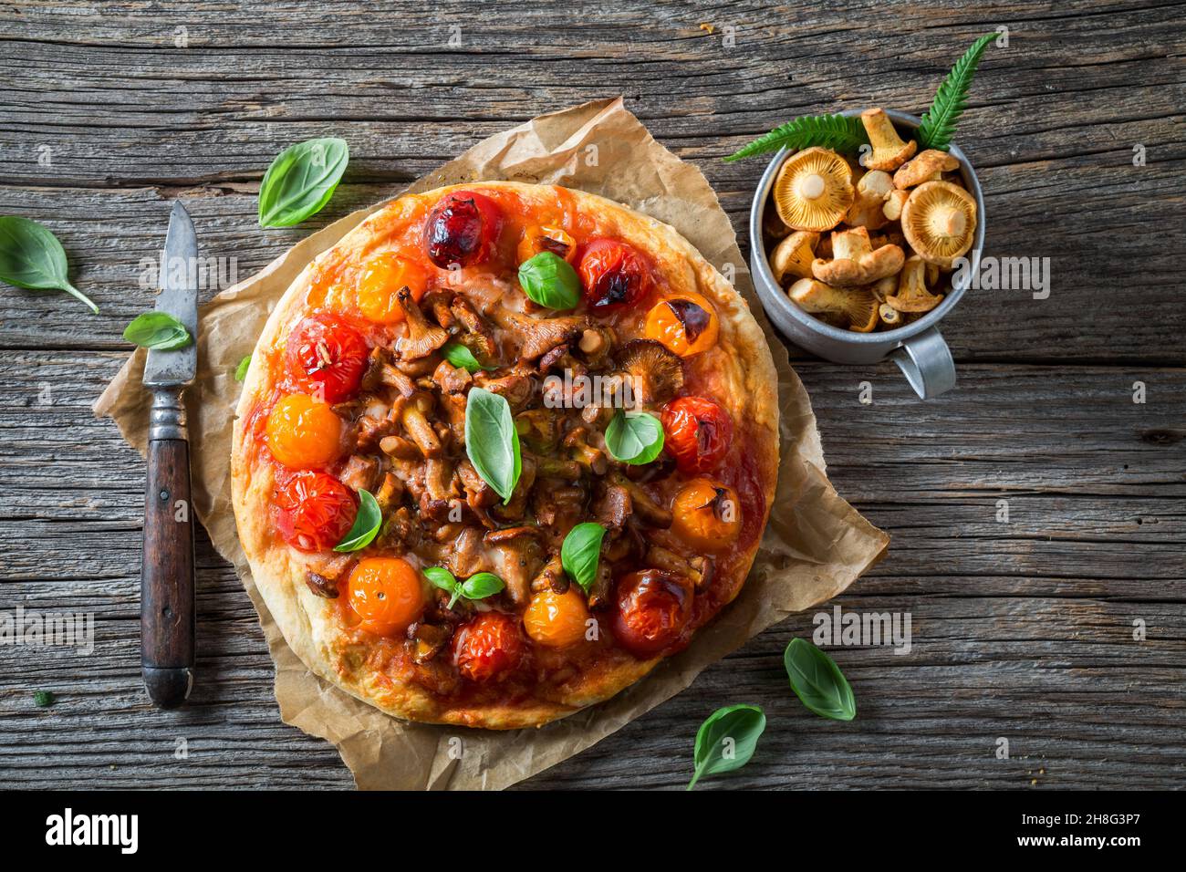 Homemade pizza with chanterelle mushrooms and vegetables. Forest