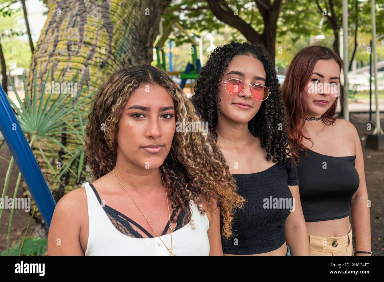 Portrait of three young women on the park Stock Photo - Alamy