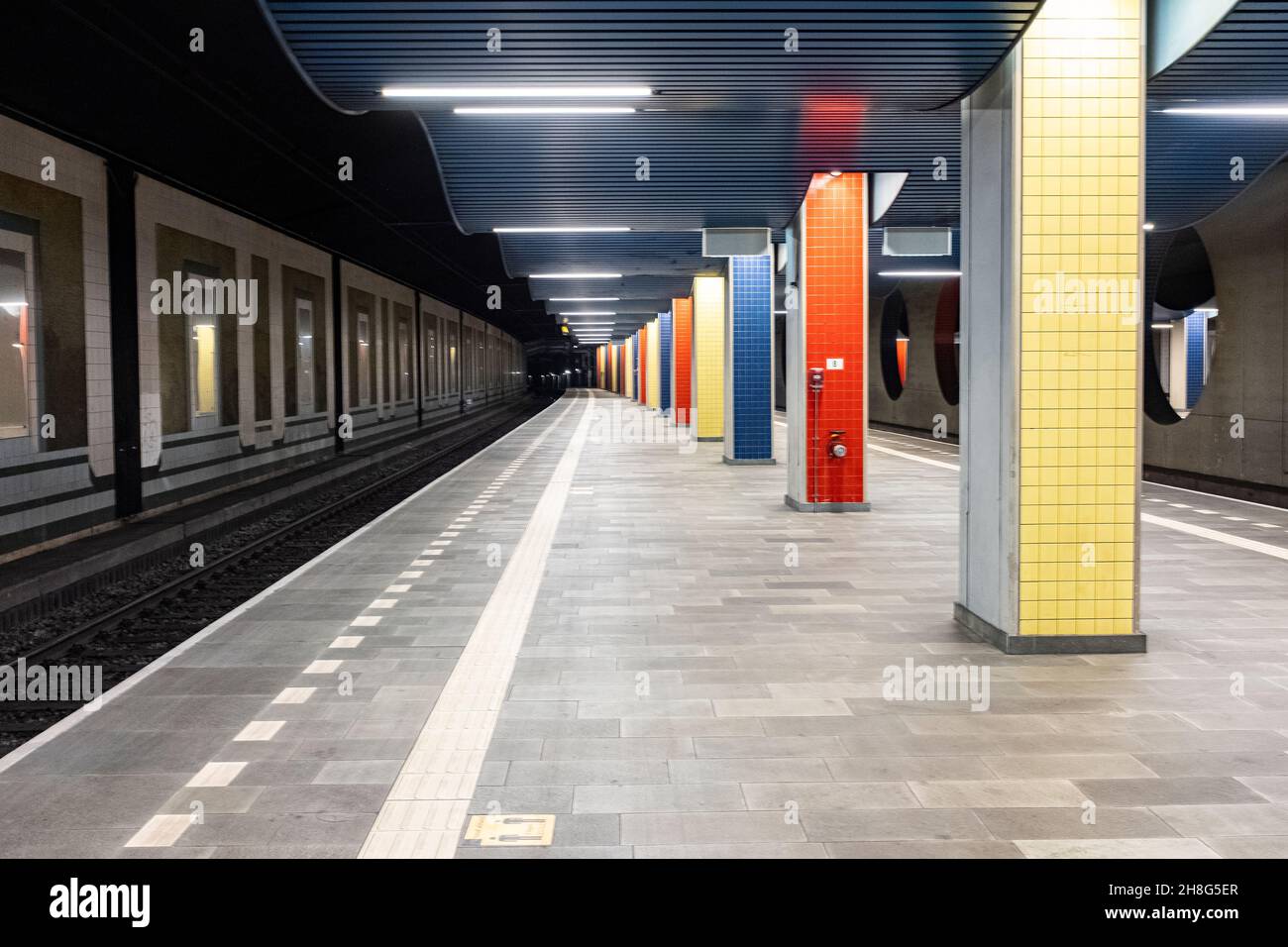 Rotterdam, Netherlands. Colorful platform interior at deserted and abandoned Blaak Railway Station due to Corona Crisis. Stock Photo