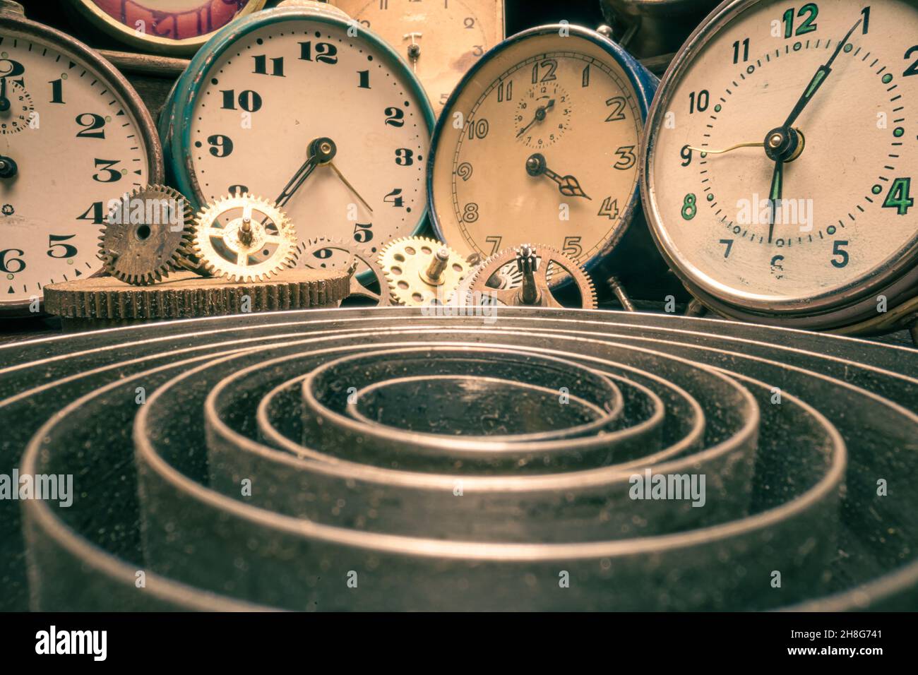 Retro watchmakers with broken clocks and parts. Old fashioned