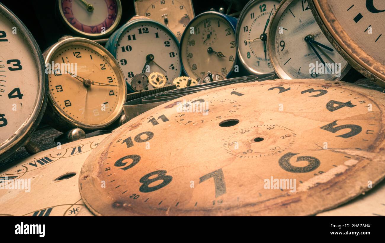 Spare parts and broken clocks. Vintage watchmakers with clocks