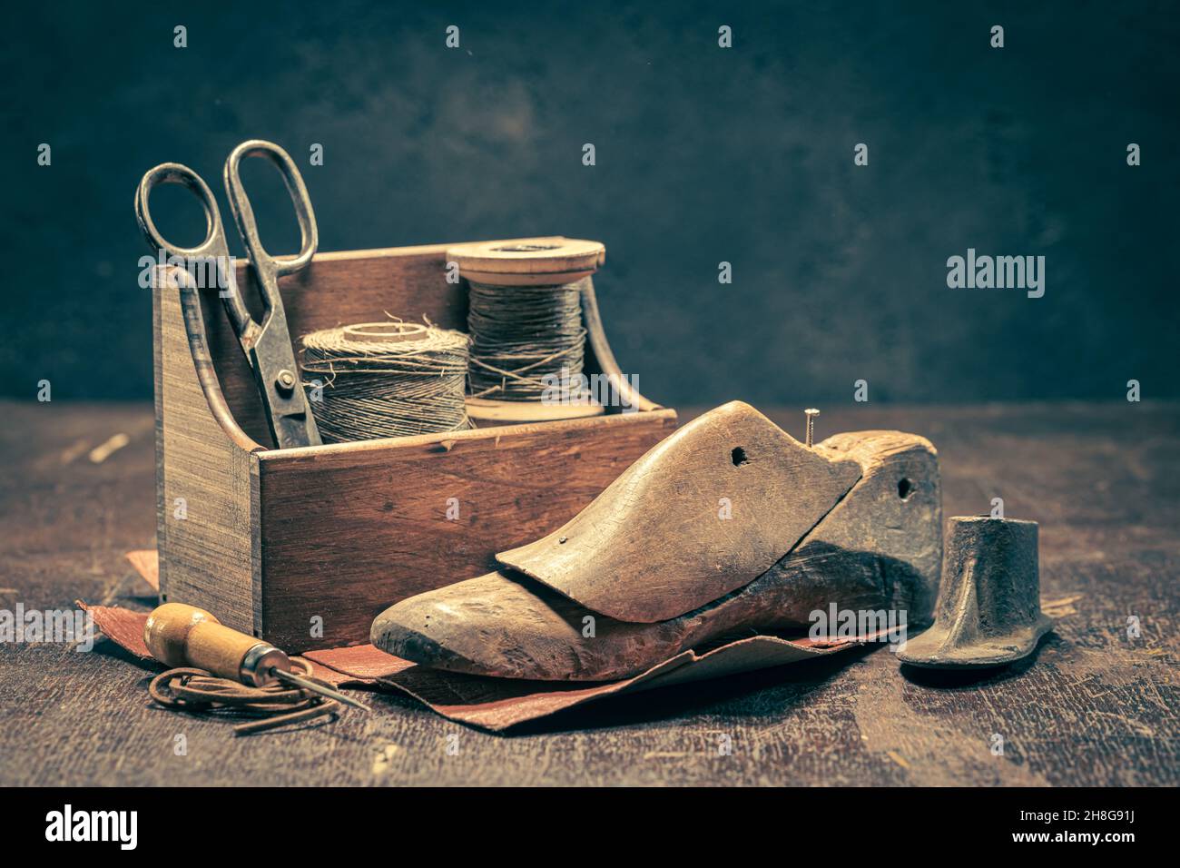 Old shoemaker workshop with tools, rules, leather and strap. Old shoemaker workshop Stock Photo
