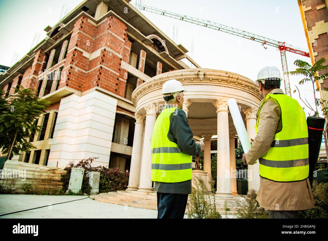 Two construction workers are looking at the construction area Stock Photo