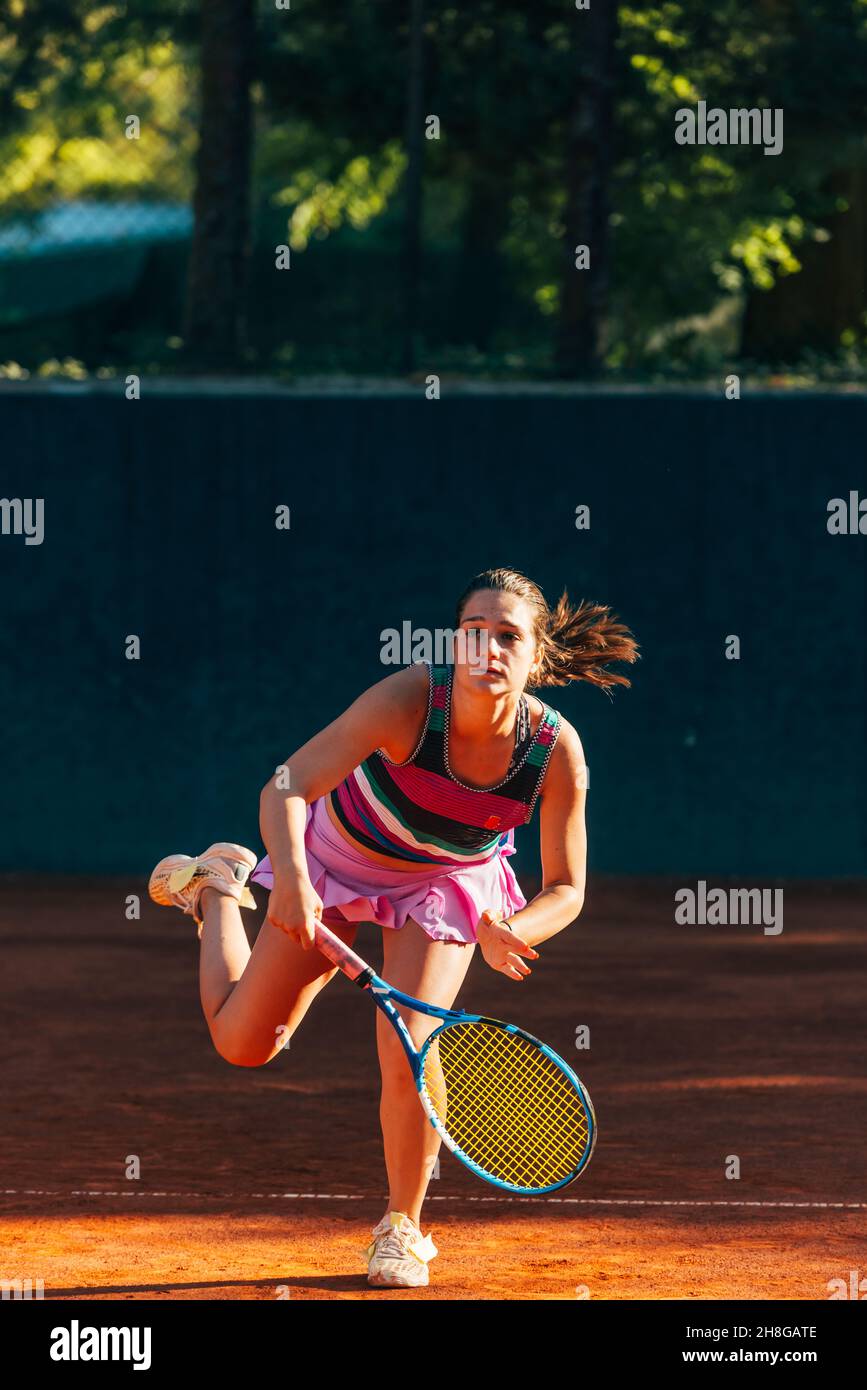 Vertical fulllength view of a sportswoman playing match on the tennis