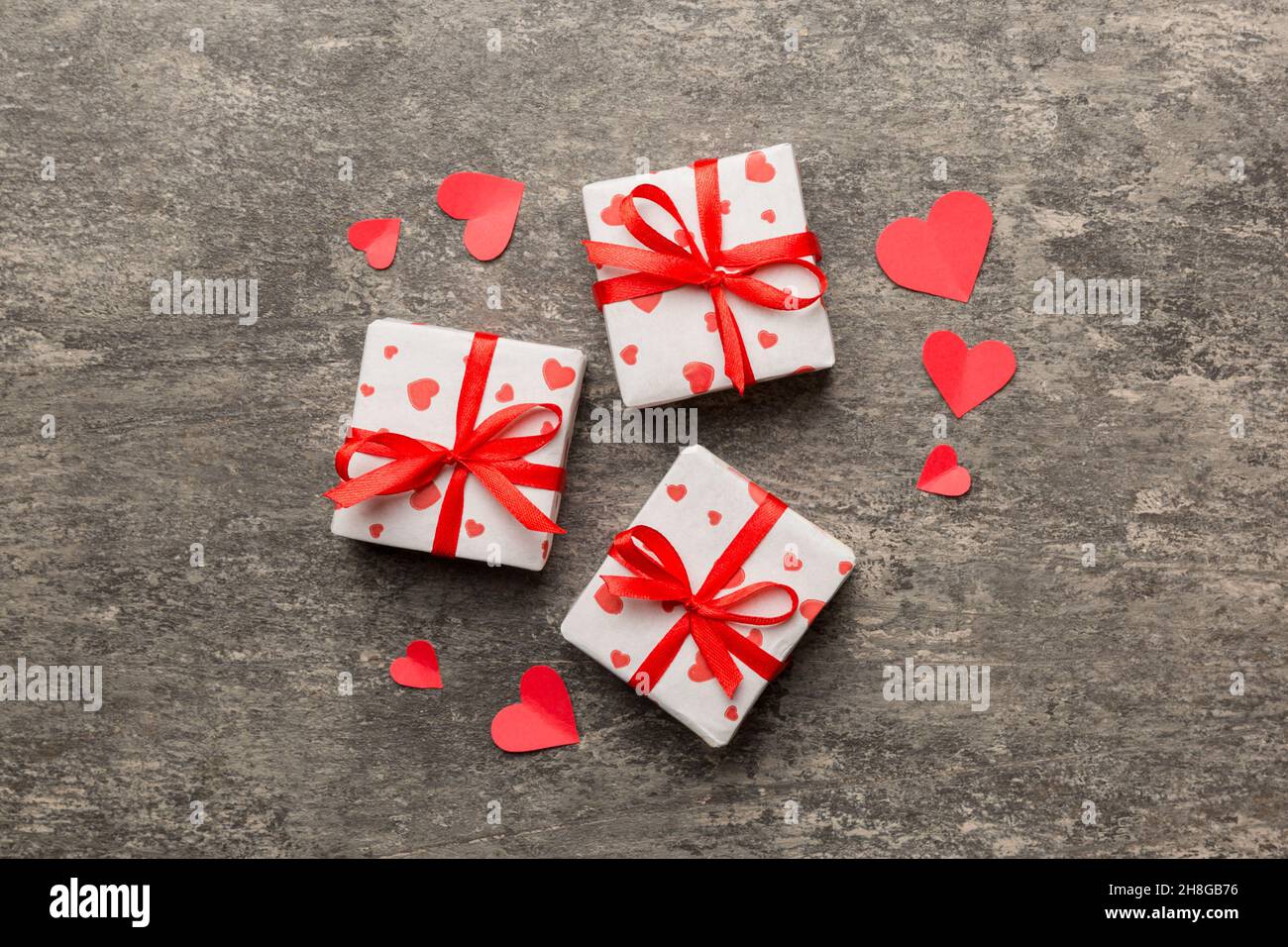 Valentine day composition Background: red gift box with bow and heart ...