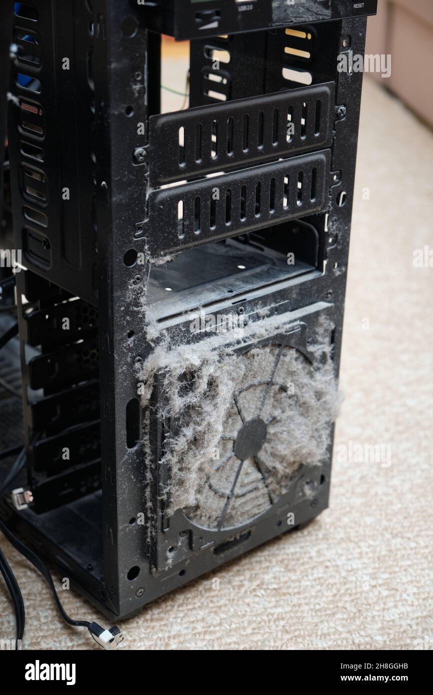 Dust on the computer pc processor cooler with mainboard and computer case fragment. Selective focus. Stock Photo