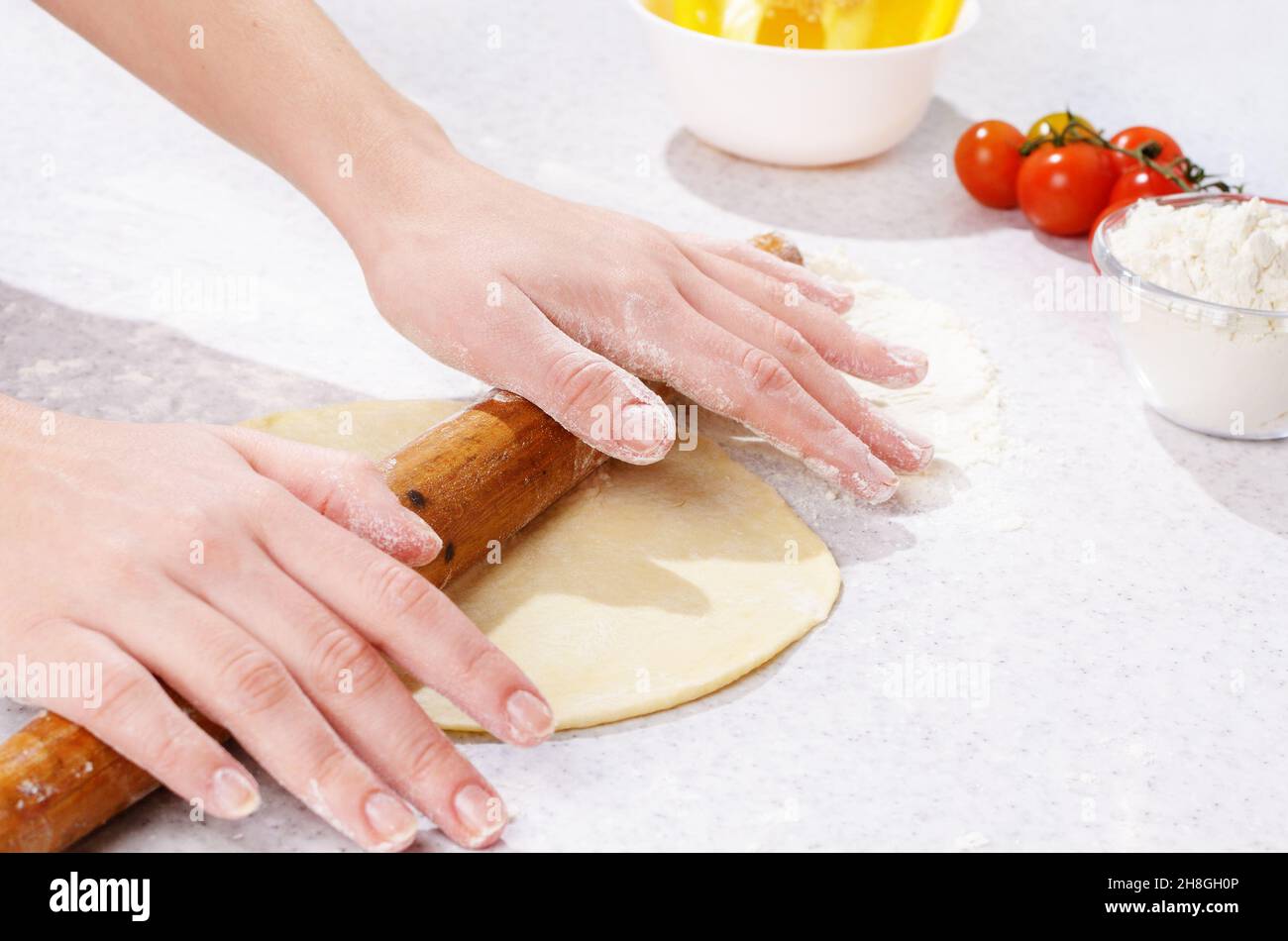 Dough preparing with wooden roller Stock Photo