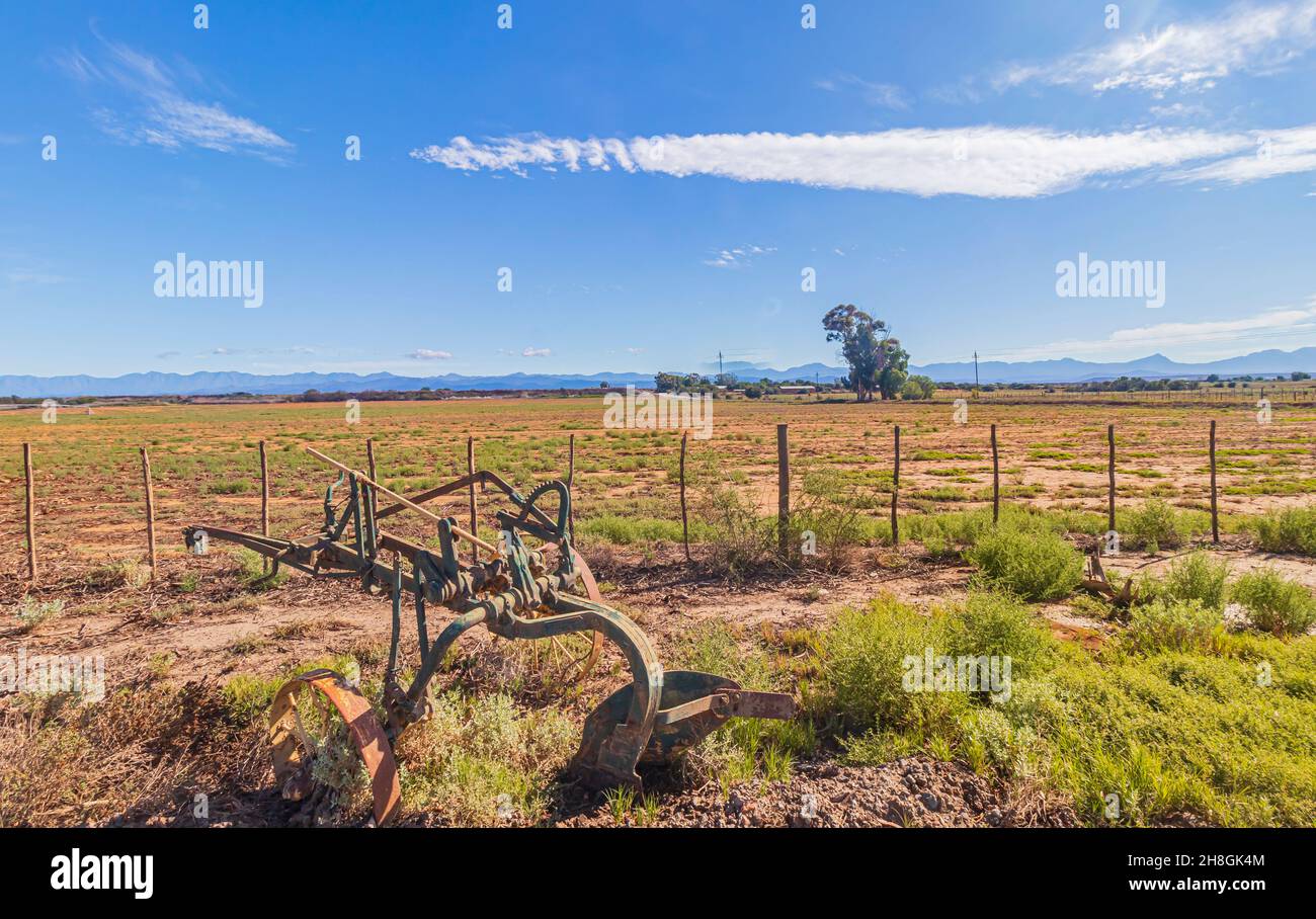 A vintage plough machine in Karoo farmland at Oudtshoorn in Western Cape, South Africa. Stock Photo