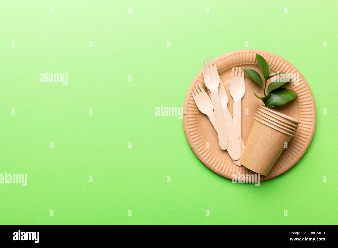 set of empty reusable disposable ecofriendly plates, cups, utensils on light white colored