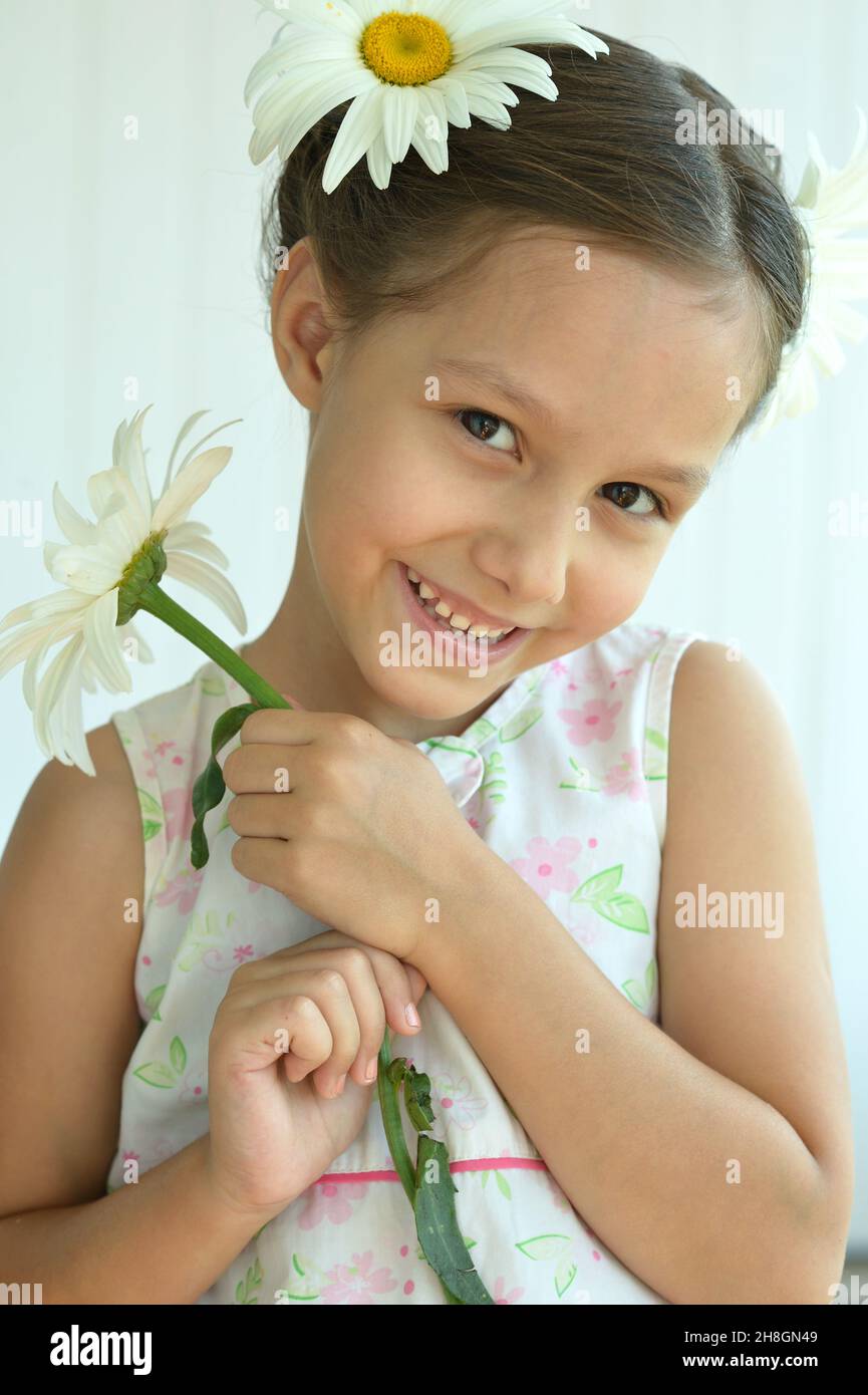 Cute little girl at home with chamomile Stock Photo - Alamy