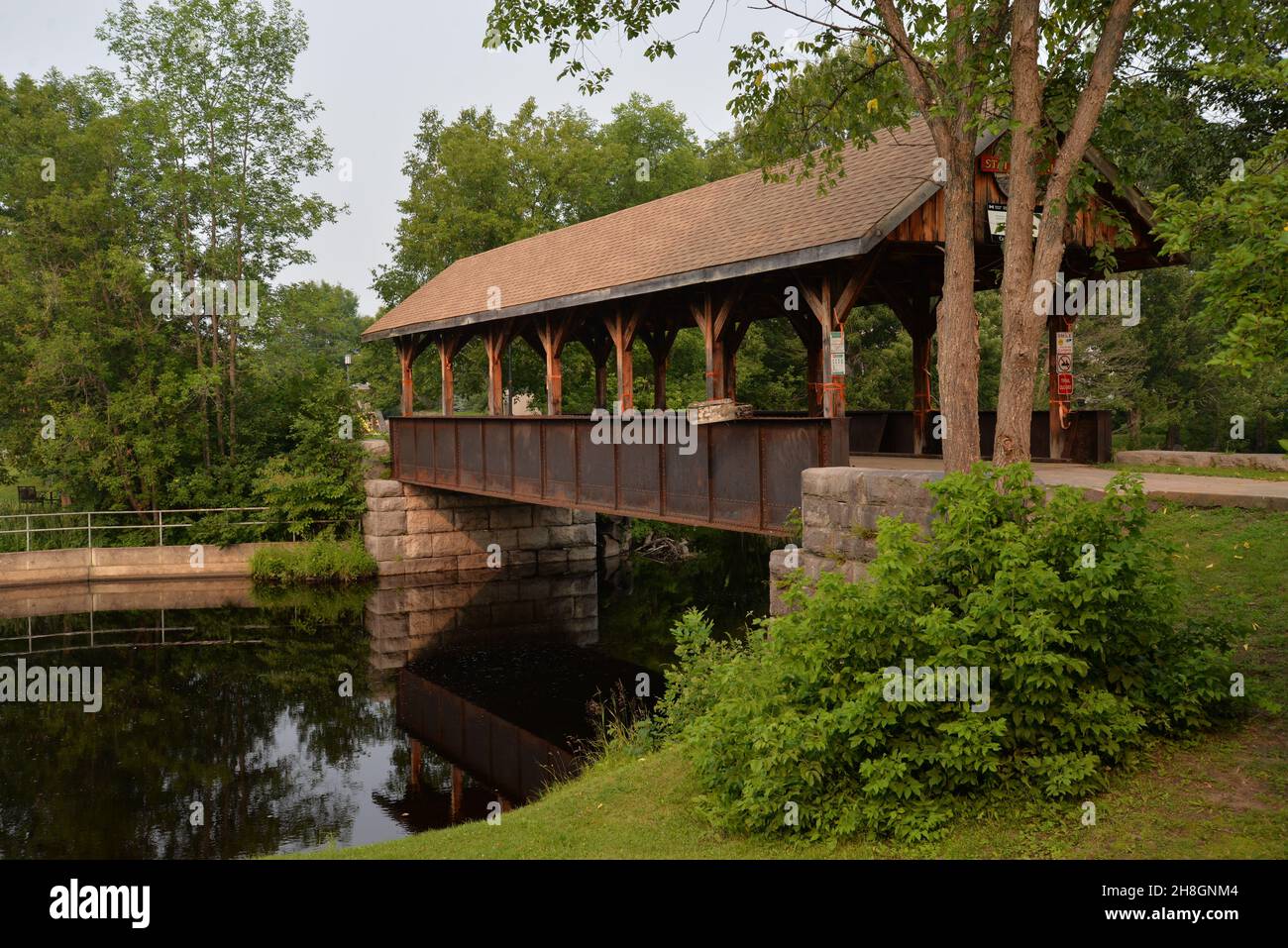 Wooden bridge surrounded by green trees in Killaloe, Ontario Canada