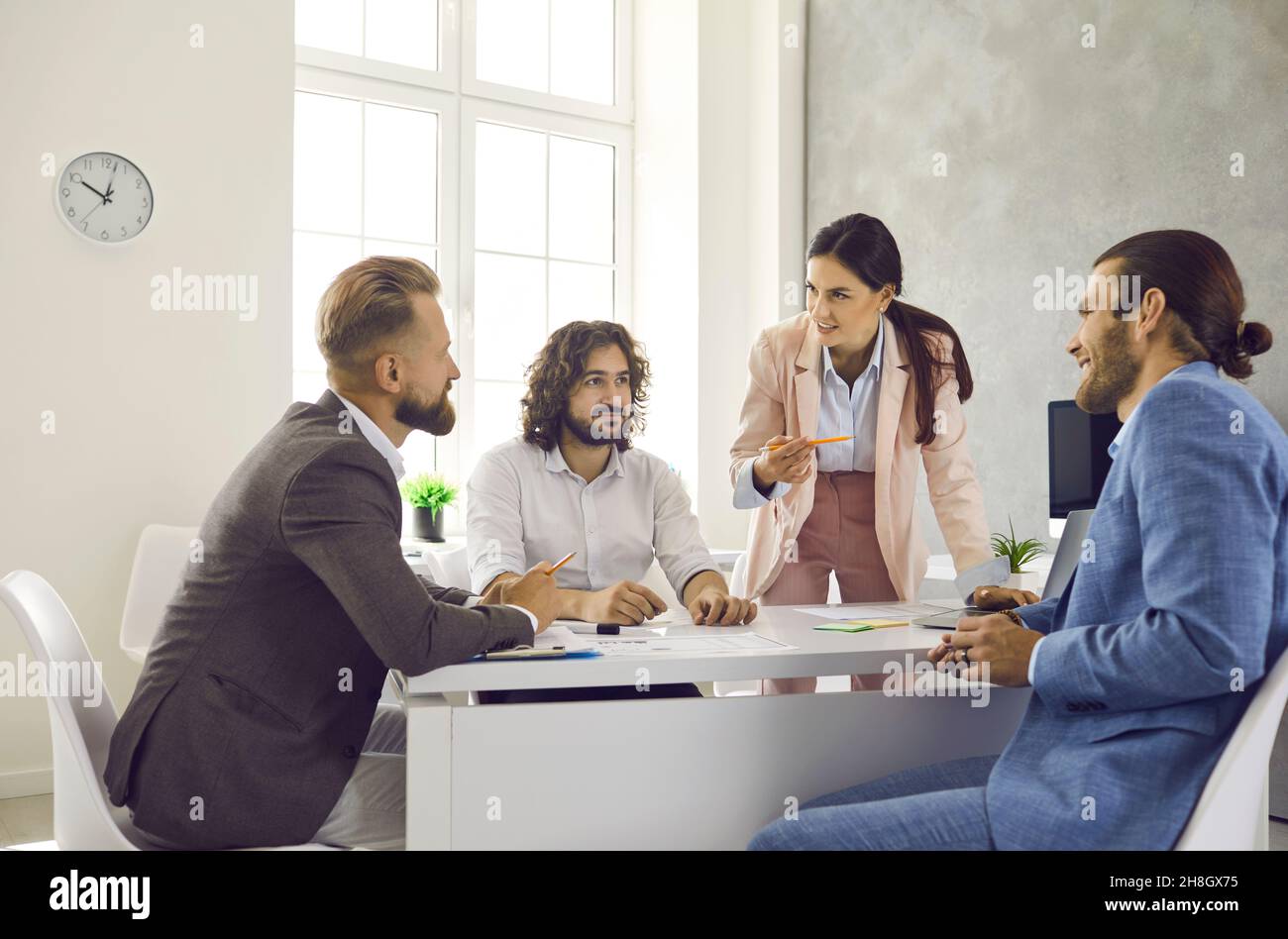 Group of people meeting around office table and working on business project together Stock Photo