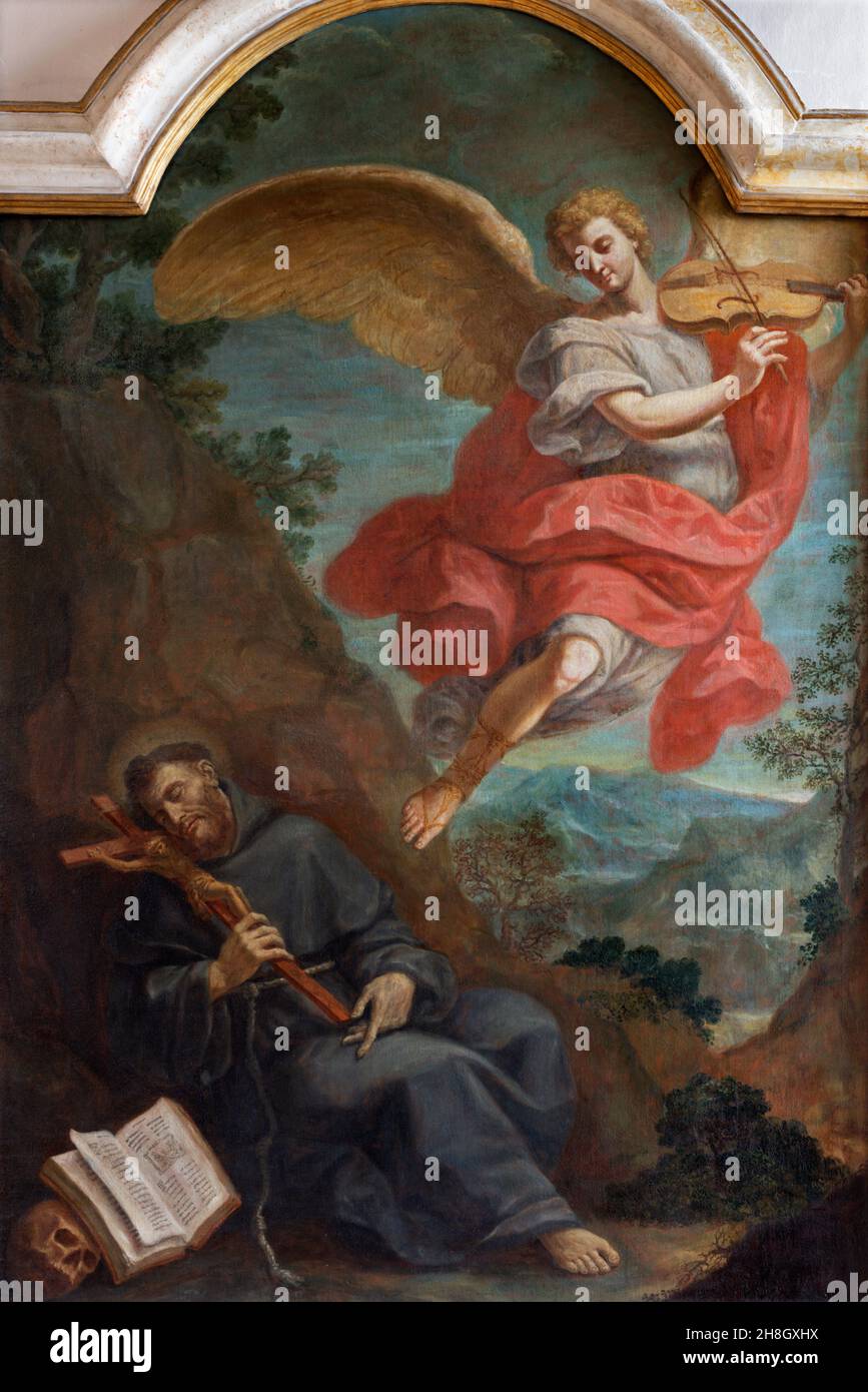 FERRARA, ITALY - NOVEMBER 9, 2021: The painting of Vision St. Francis of Assisi with the angel playing violin in church Chiesa di San Francesco Stock Photo