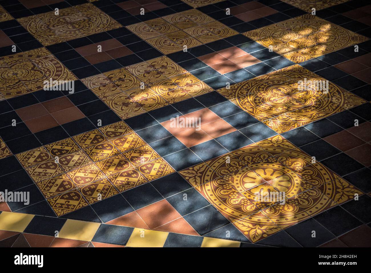 Light from stained glass windows on tiled floor, St Davids Cathedral