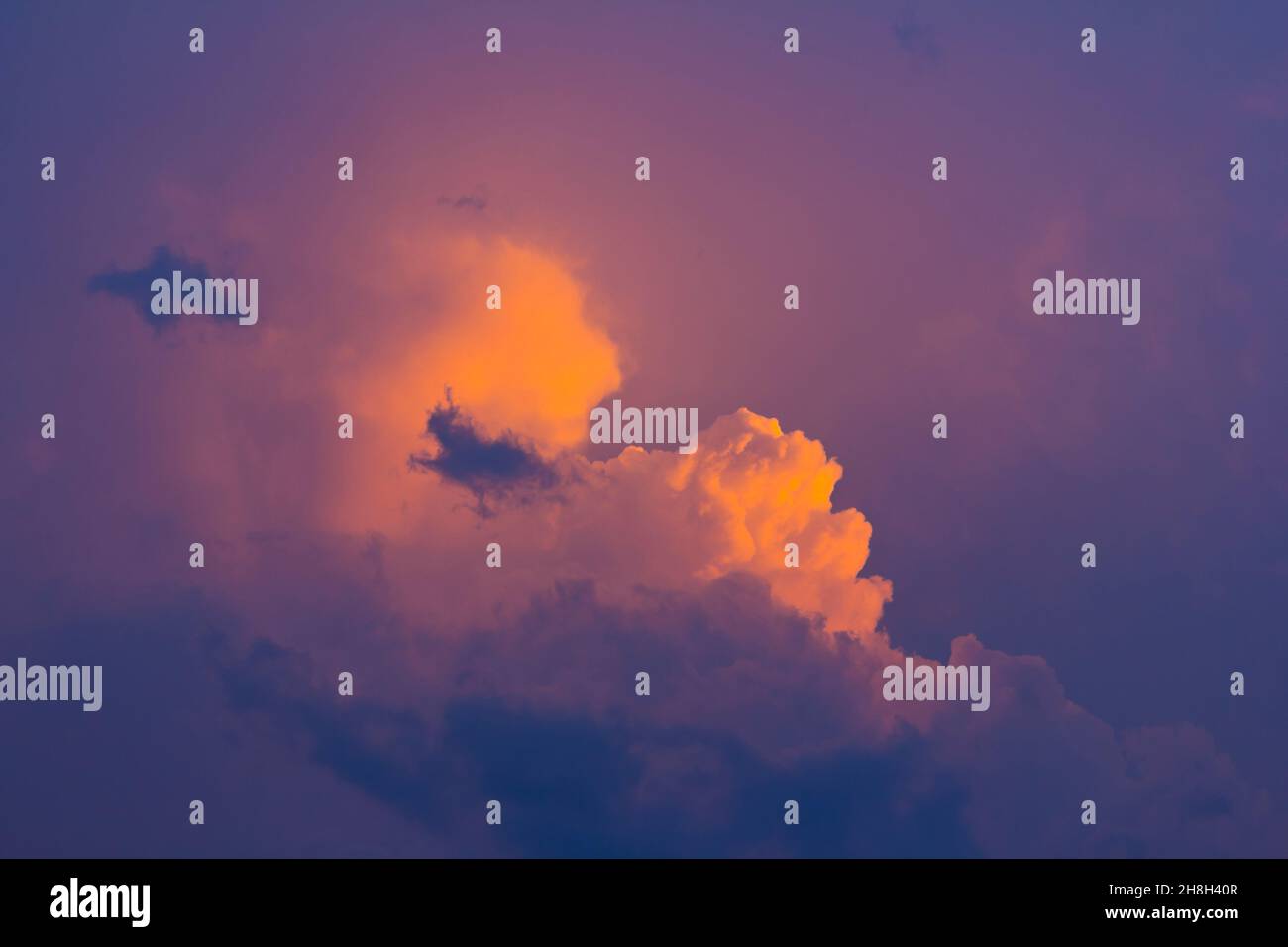 Colorful and dramatic sky with orange and blue clouds at sunset ...