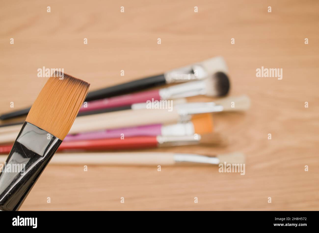 fine paintbrushes on a wooden worktop with space for text Stock Photo ...