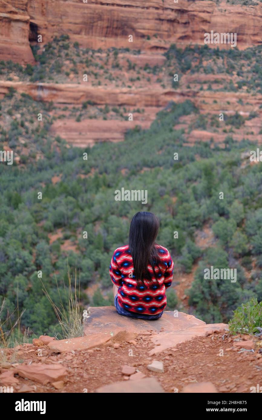 Woman sitting on the edge of a cliff in Sedona, Arizona Stock Photo - Alamy