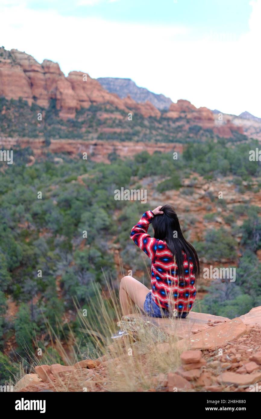 Woman sitting on the edge of a cliff in Sedona, Arizona Stock Photo - Alamy