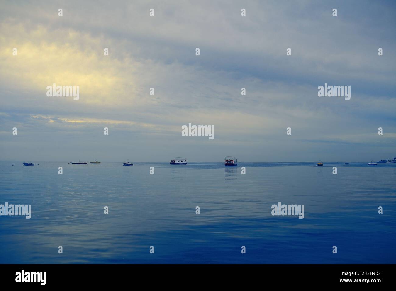 Pleasure crafts in the sea under a cloudy sky Stock Photo Alamy