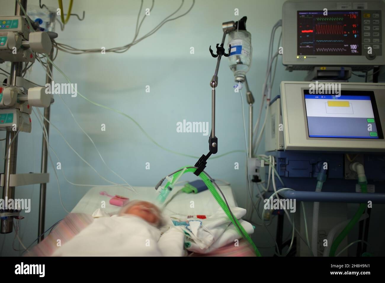 Child in the NICU connected to the life support device. Stock Photo